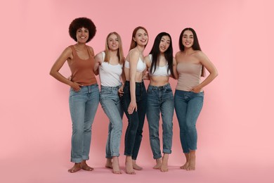 Group of beautiful young women on pink background