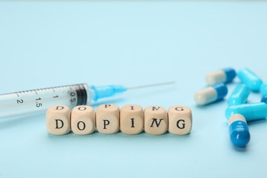 Wooden cubes with word Doping and drugs on turquoise background