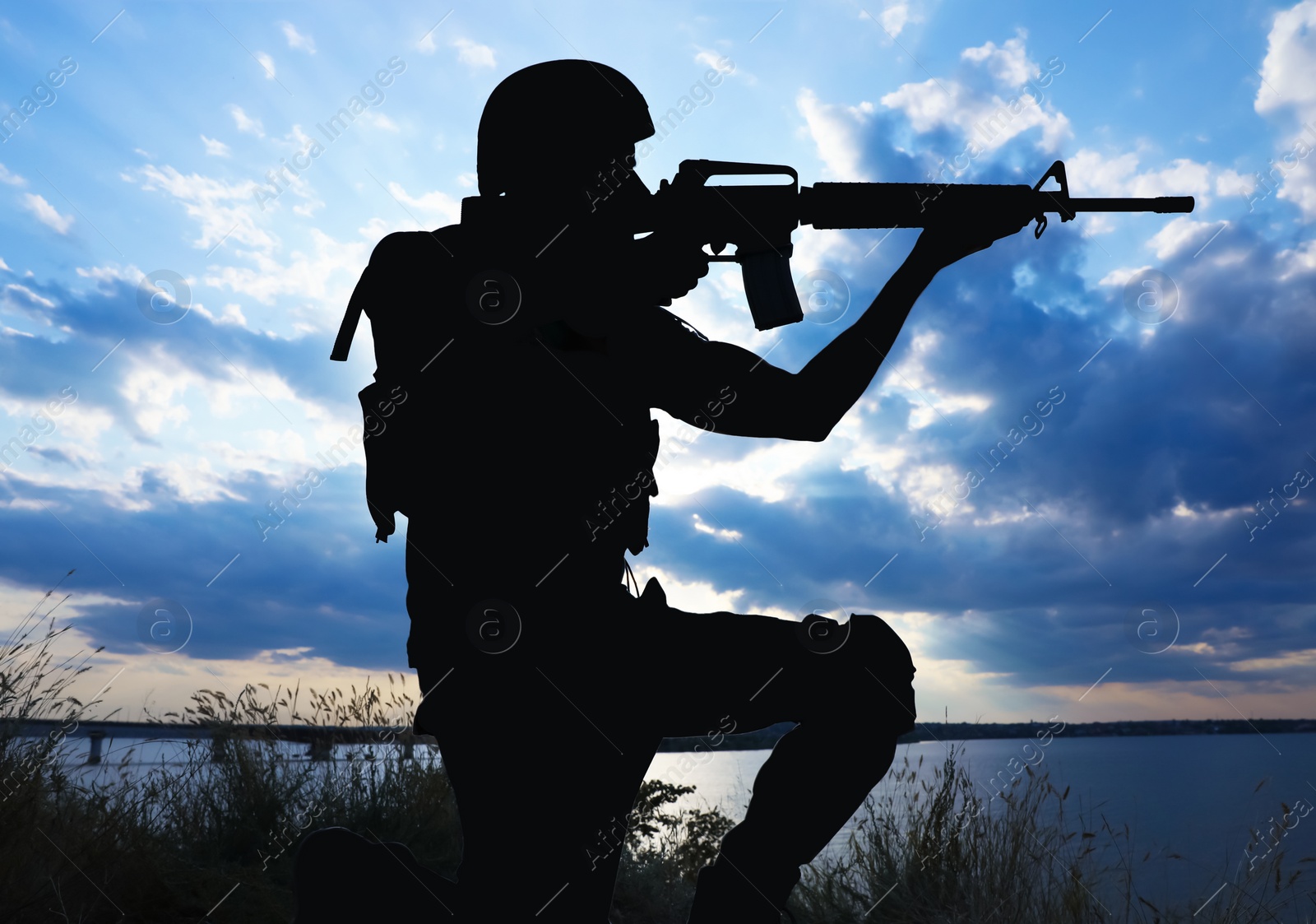 Photo of Soldier with machine gun patrolling outdoors. Military service