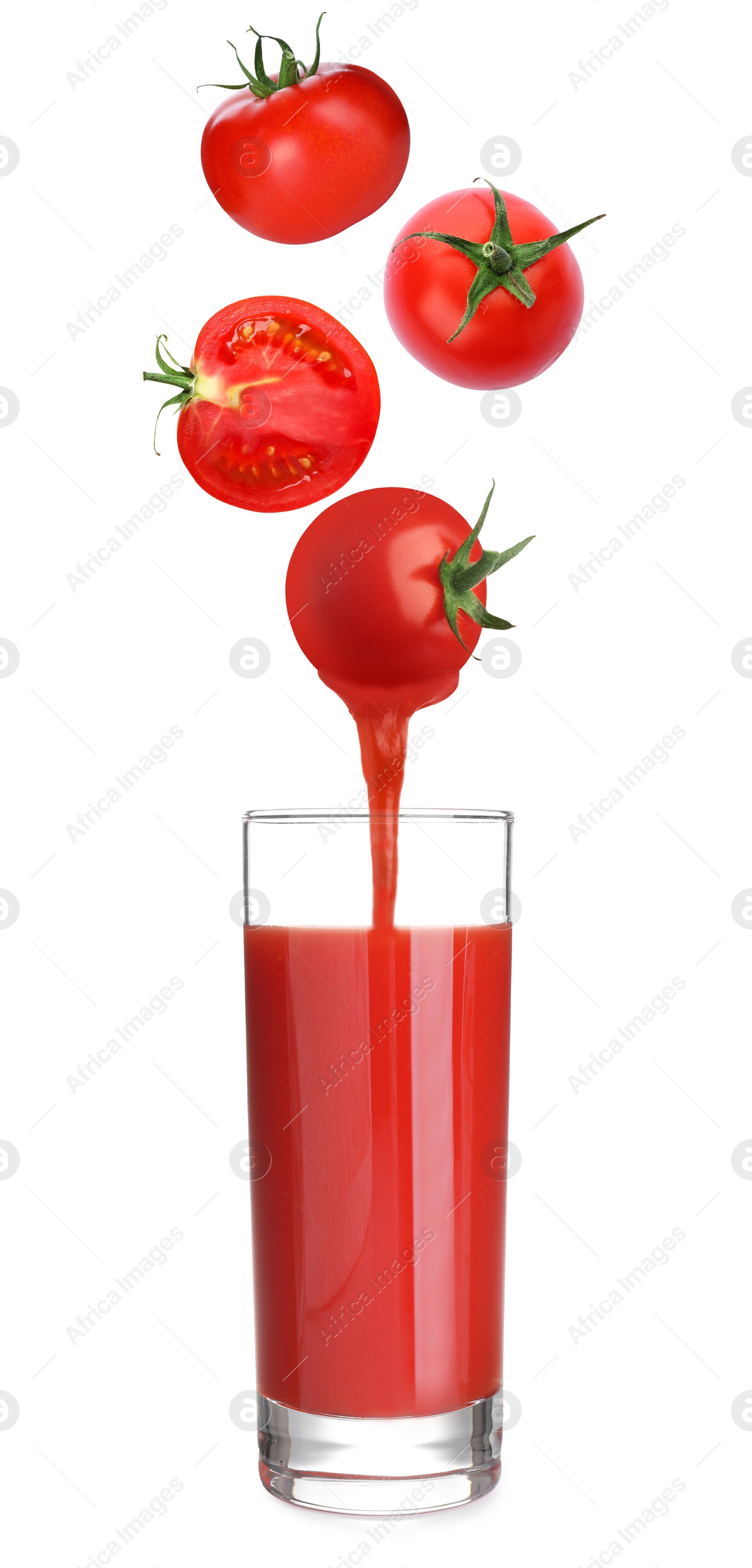 Image of Freshly made organic tomato juice. Vegetables over glass on white background