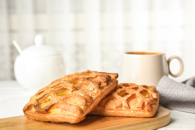 Photo of Fresh tasty pastries on white wooden table, closeup