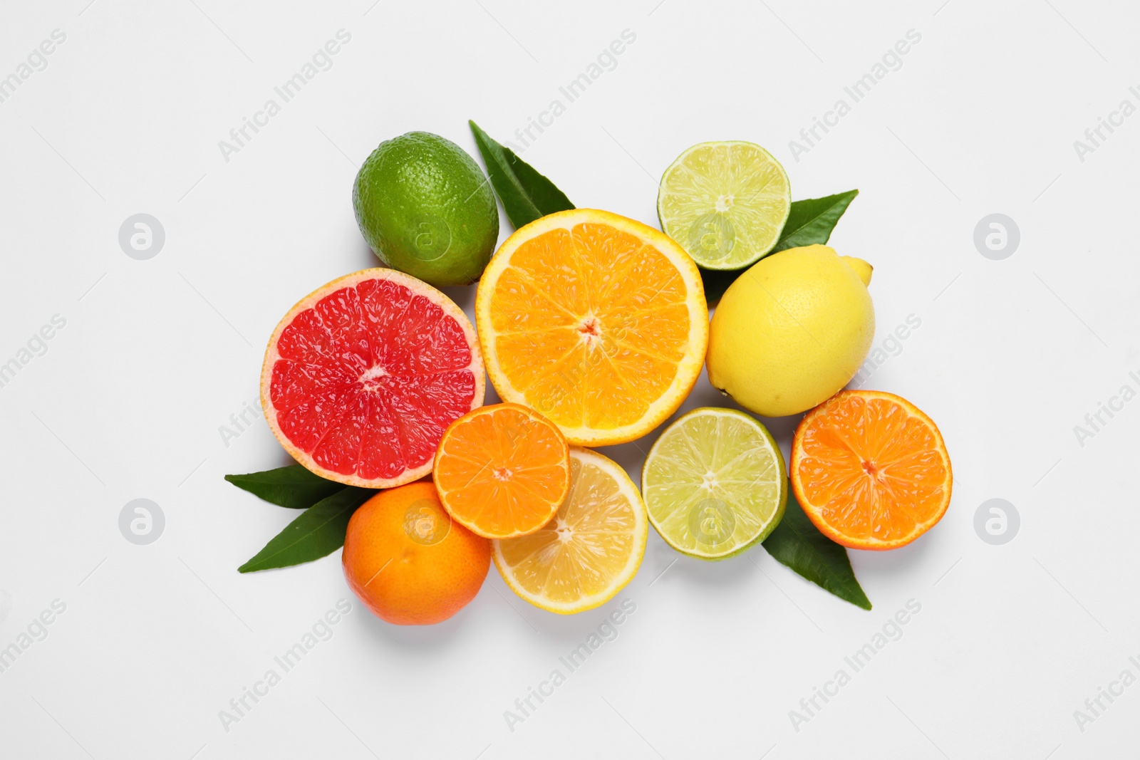 Photo of Different citrus fruits with fresh leaves on white background, top view