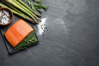 Photo of Fresh raw salmon and ingredients for marinade on black table, flat lay. Space for text