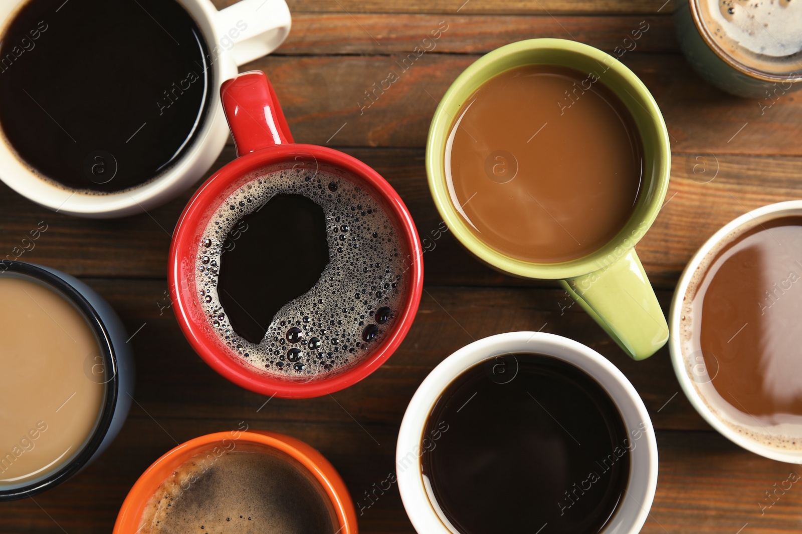 Photo of Flat lay composition with cups of coffee on wooden background. Food photography