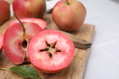 Photo of Tasty apples with red pulp on table, closeup