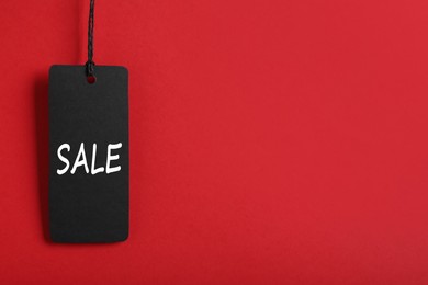 Sale tag on red background, space for text. Black Friday