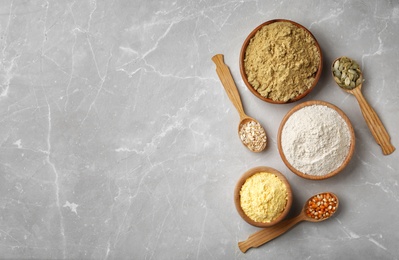 Photo of Bowls with different types of flour on light background