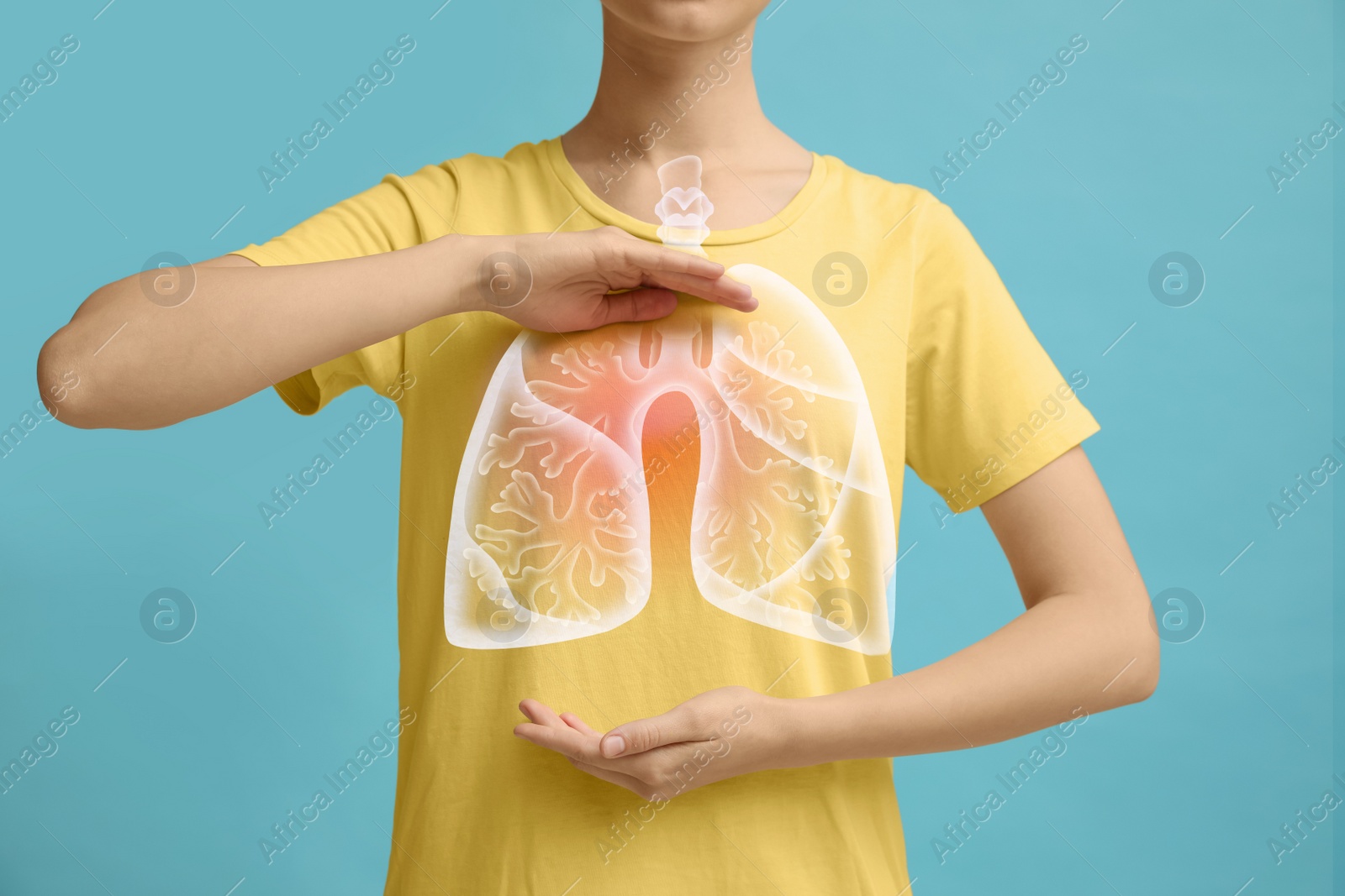 Image of Woman holding hands near chest with illustration of lungs on turquoise background, closeup