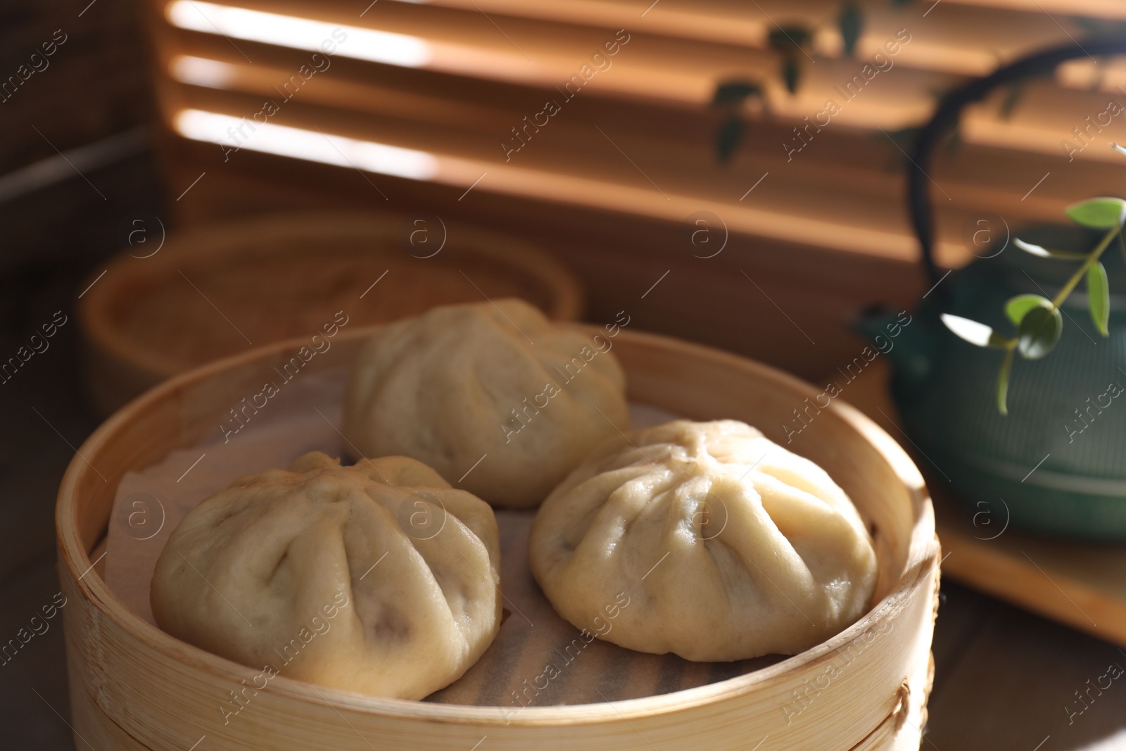 Photo of Delicious bao buns (baozi) on table, closeup