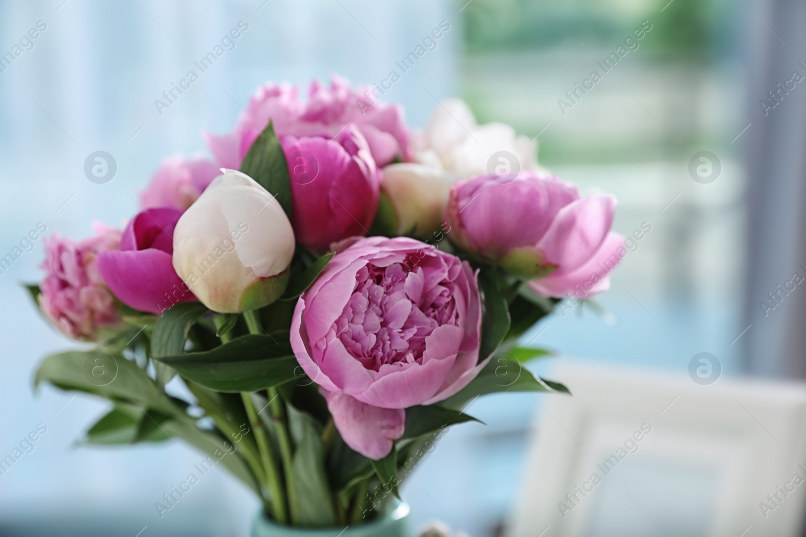 Photo of Bouquet of beautiful peonies in room, closeup