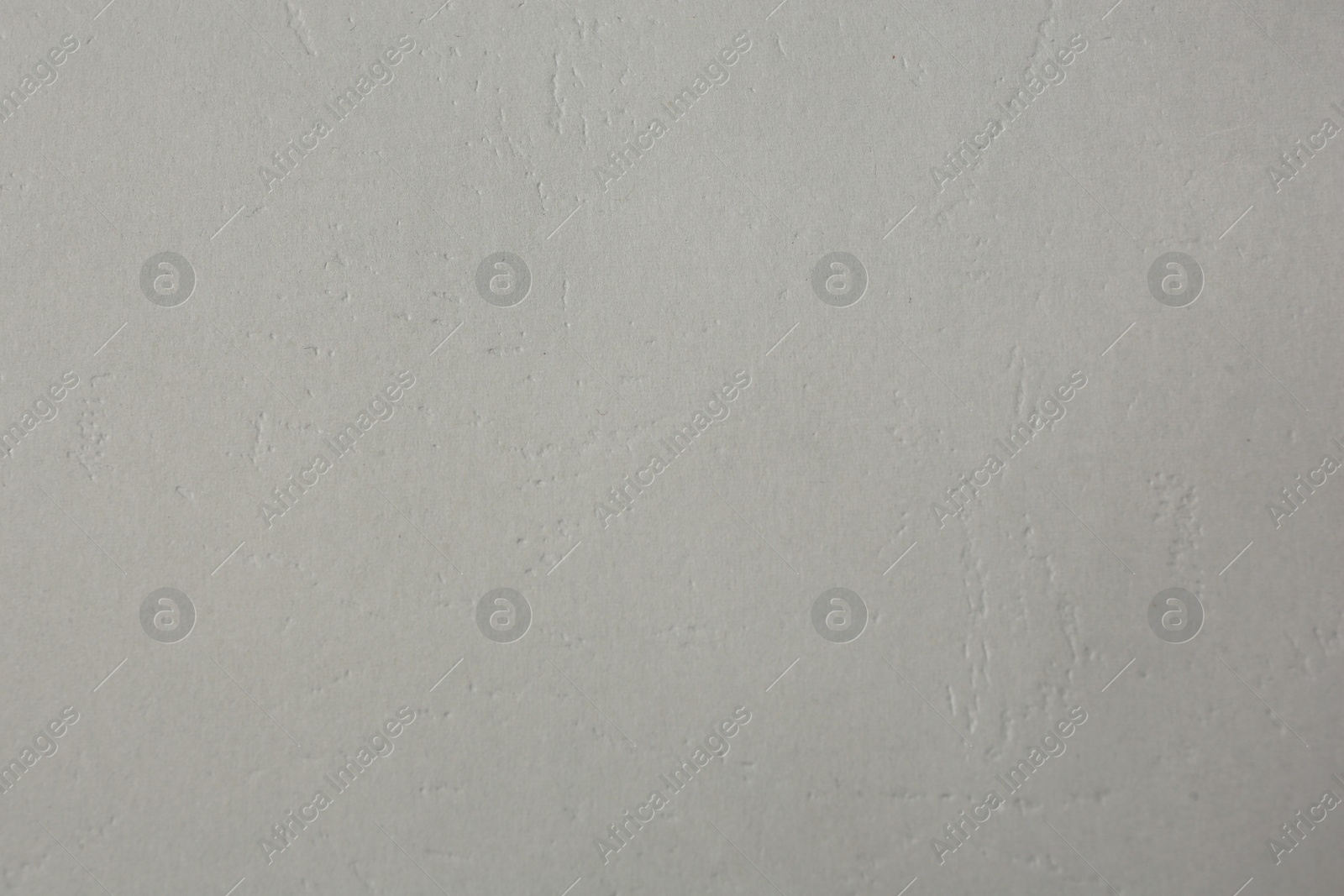 Photo of Texture of light grey paper sheet as background, closeup