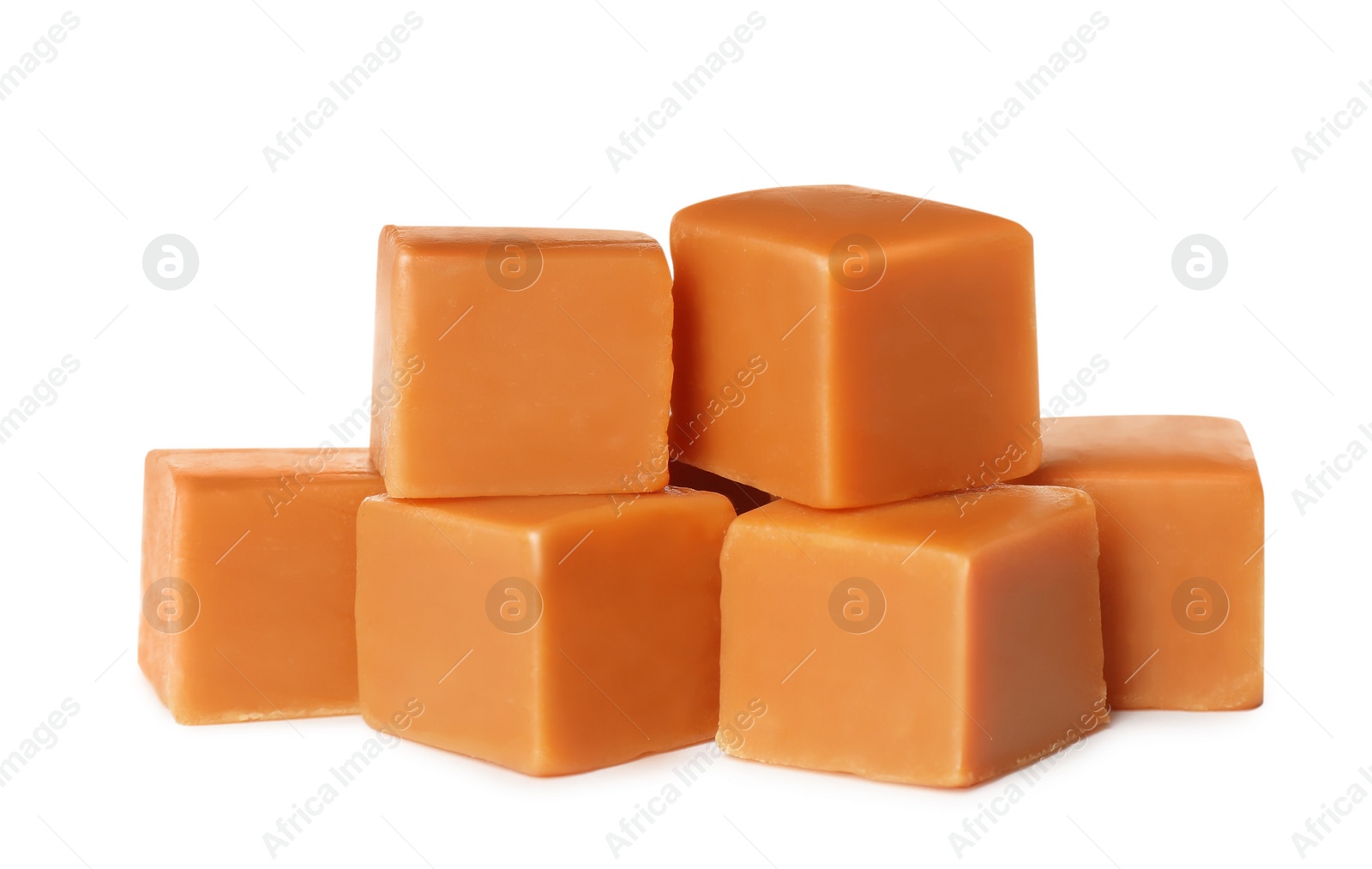 Photo of Many caramel cubes on white background. Confectionery