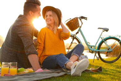 Happy young couple having picnic outdoors on sunny day