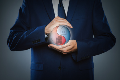 Businessman showing balance between life and work on dark background, closeup