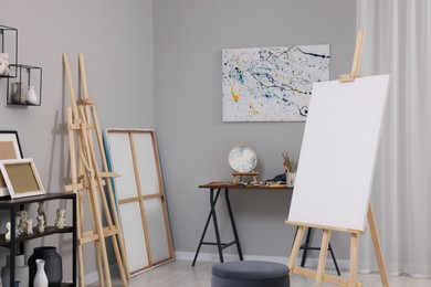 Photo of Artist's studio with easels, canvases and painting supplies