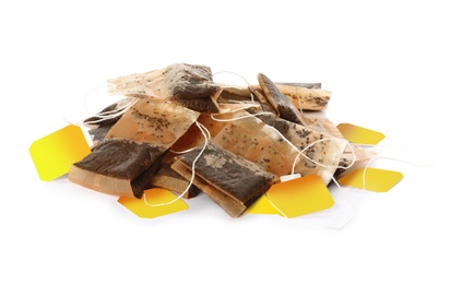 Photo of Many used tea bags on white background