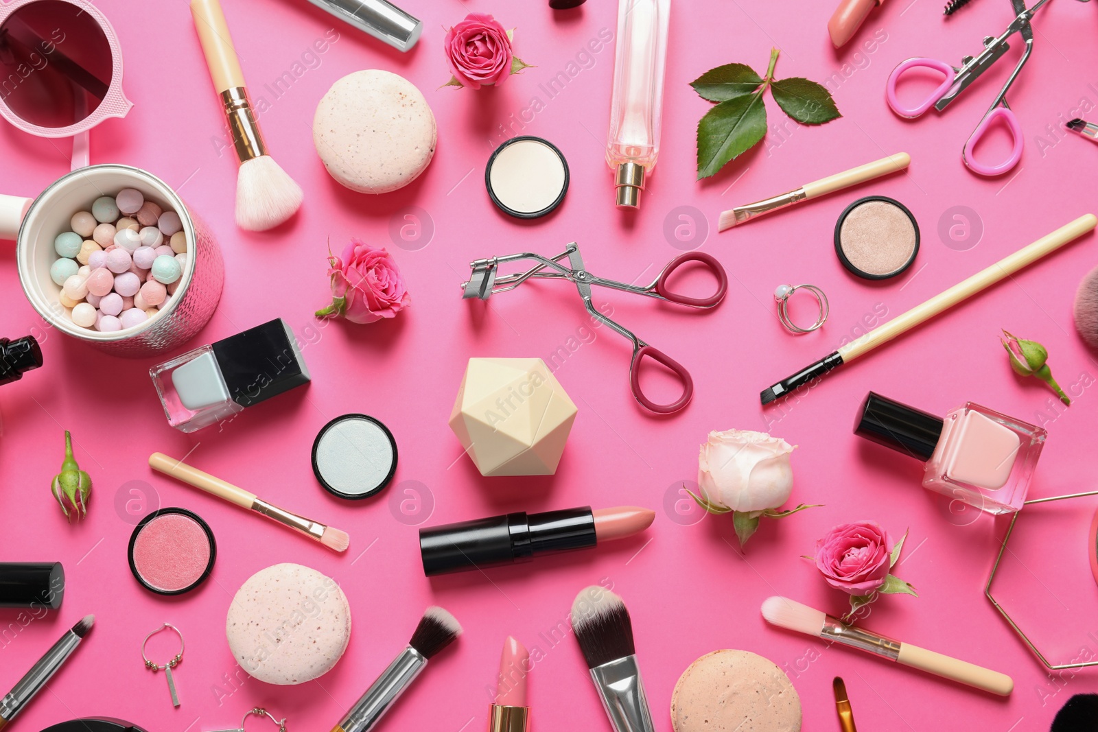 Photo of Flat lay composition with products for decorative makeup on pink background