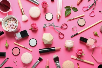 Flat lay composition with products for decorative makeup on pink background