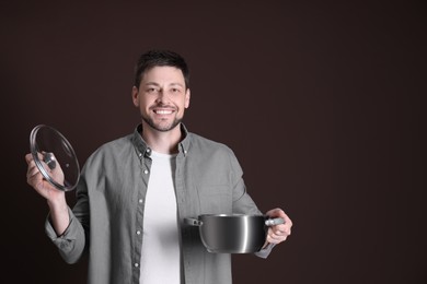 Happy man with pot on dark background. Space for text