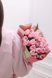 Photo of Woman with bouquet of beautiful fresh tulips on blurred background, closeup