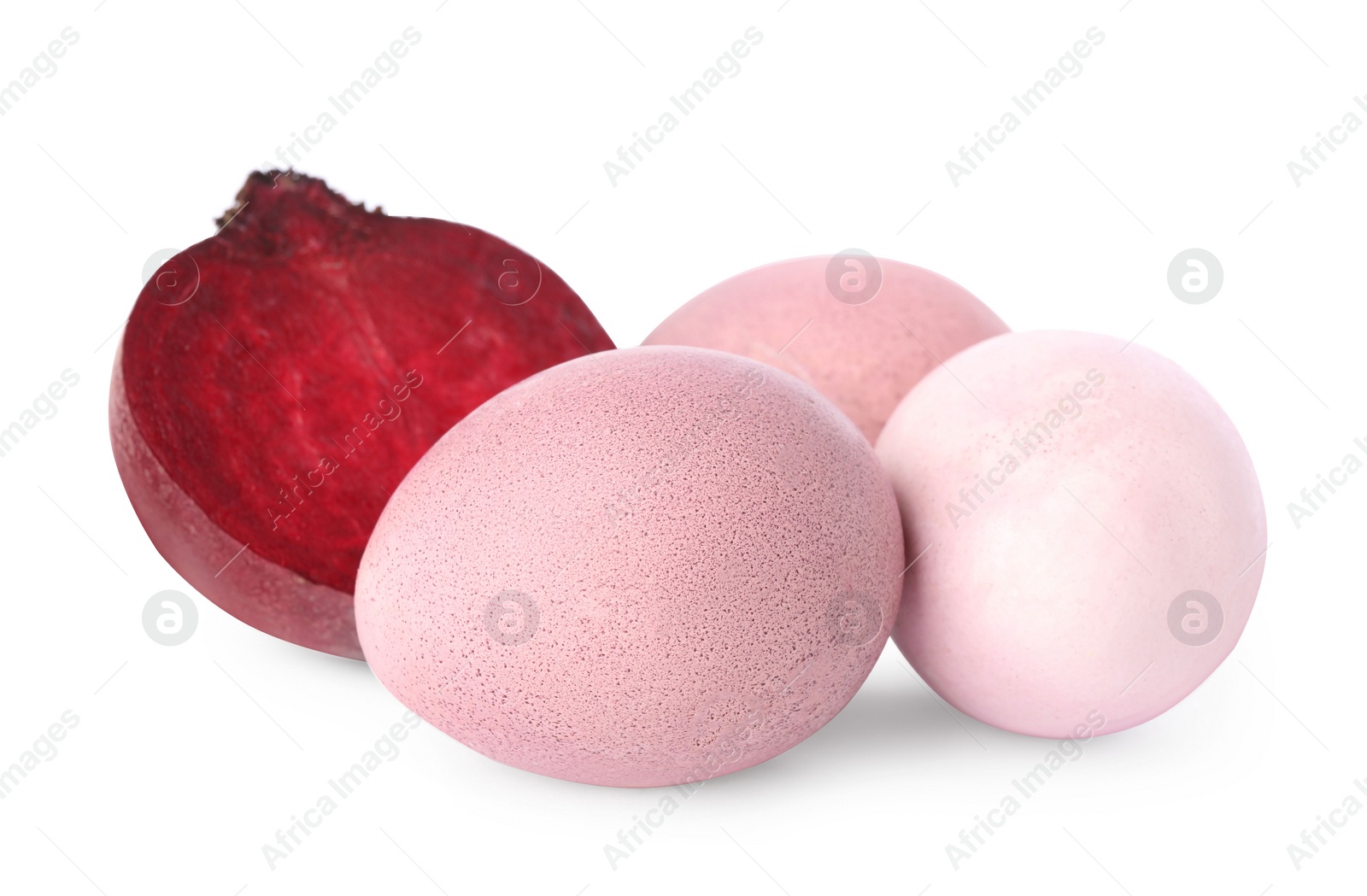 Photo of Colorful Easter eggs painted with natural dye and cut beet on white background