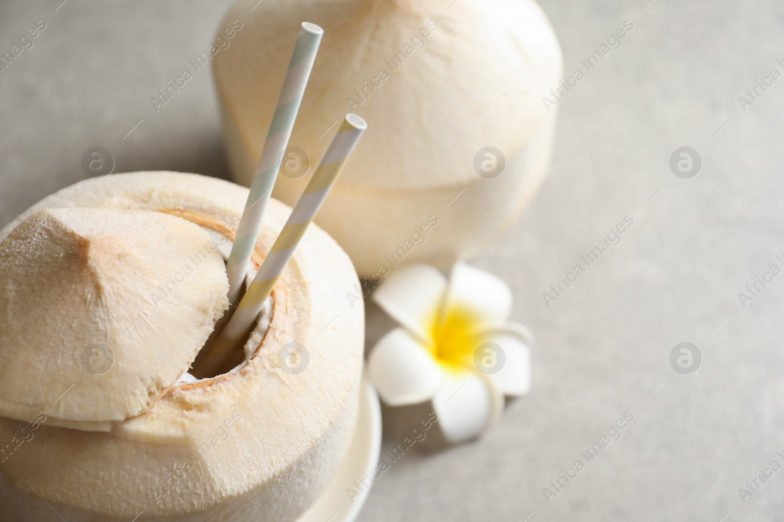 Photo of Fresh coconut drink in nut on table, closeup