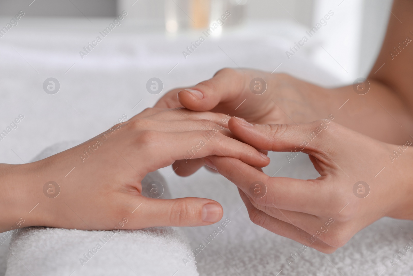 Photo of Woman receiving hand massage in wellness center, closeup