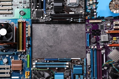 Photo of Frame of computer motherboards on grey table, flat lay with space for text. Electronic device