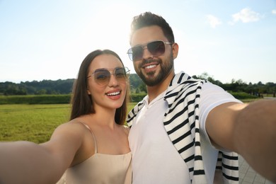 Photo of Romantic date. Beautiful couple making selfie outdoors