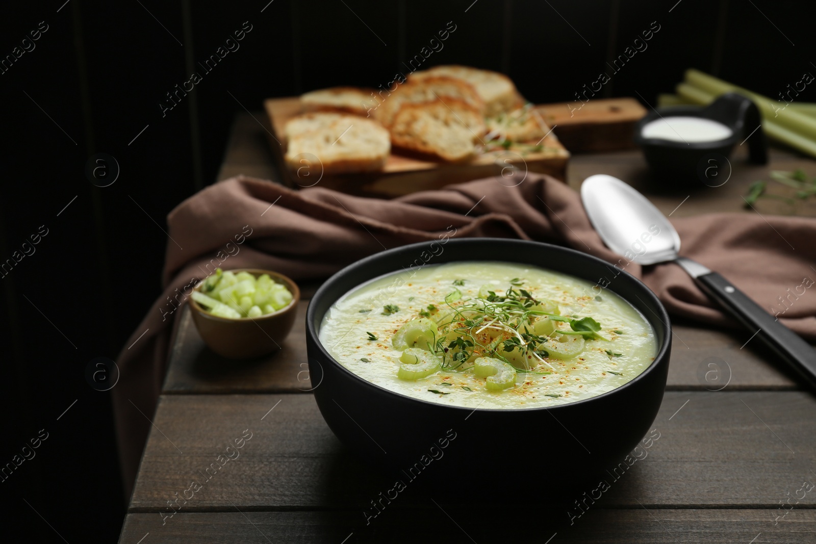 Photo of Bowl of delicious celery soup on wooden table