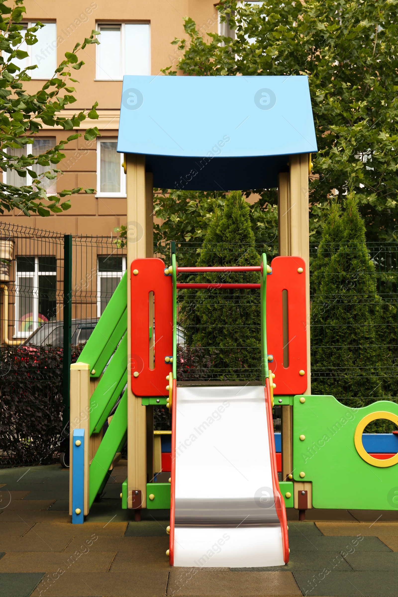 Photo of Empty outdoor children's playground with slide in residential area