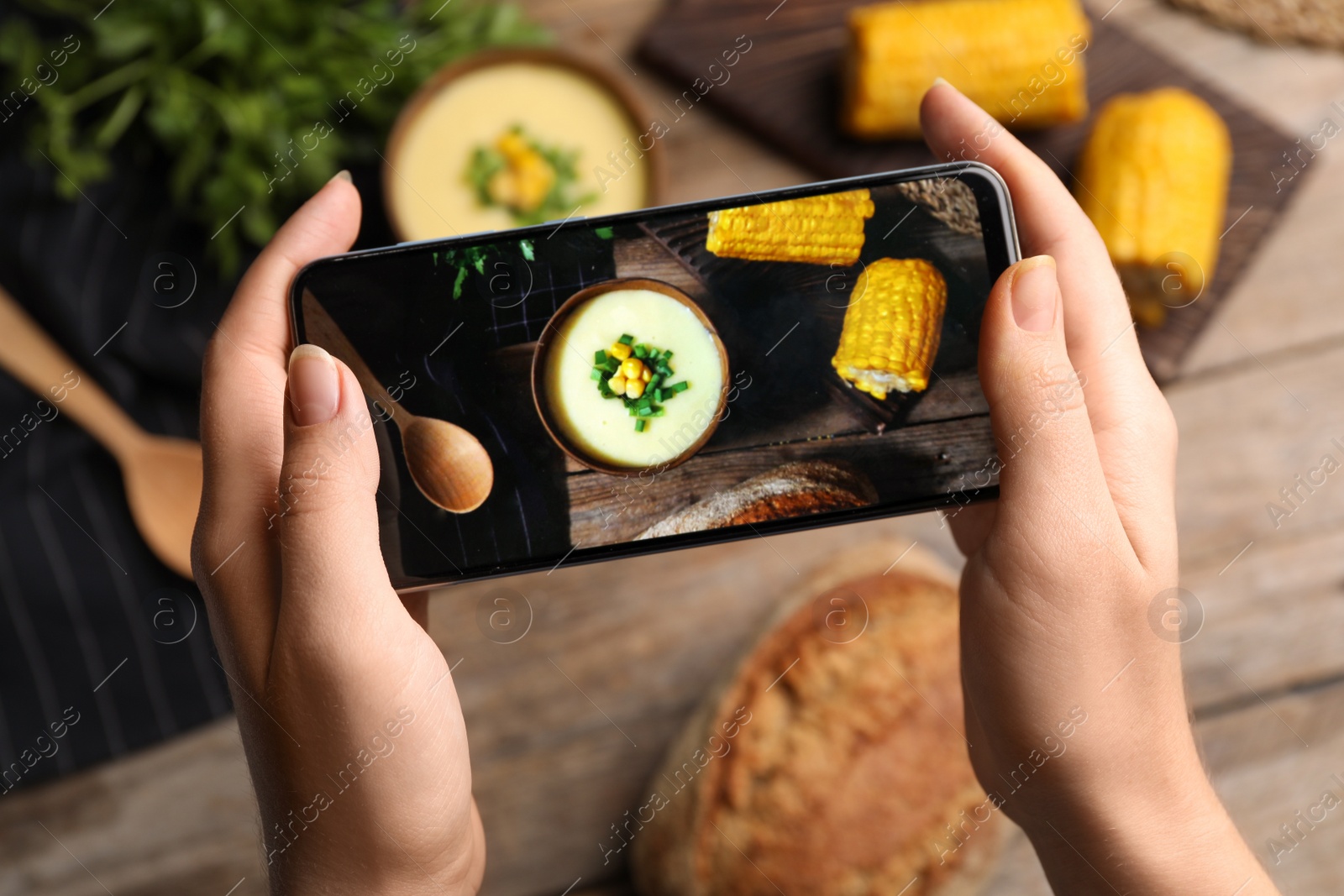 Photo of Blogger taking photo of dinner at table, closeup