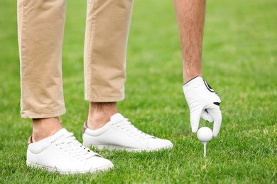 Photo of Man playing golf on green course. Sport and leisure