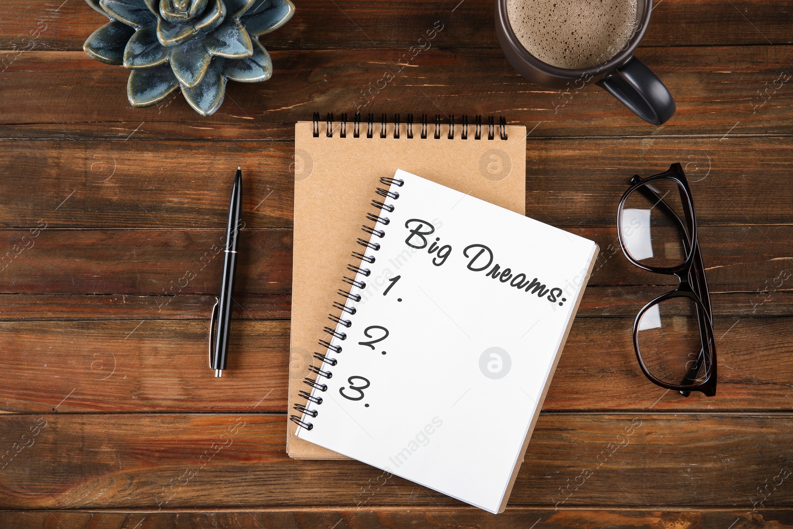 Image of Notebook with dreams list on wooden table, flat lay 