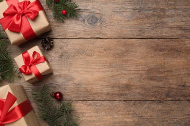 Photo of Flat lay composition with Christmas gifts on wooden table, space for text. Boxing day