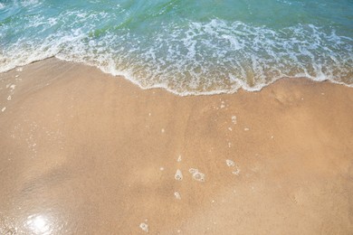 Photo of Tropical sandy beach washed by sea on sunny day