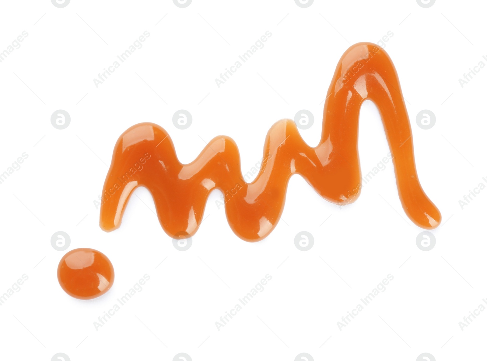 Photo of Stroke of delicious caramel sauce on white background, top view