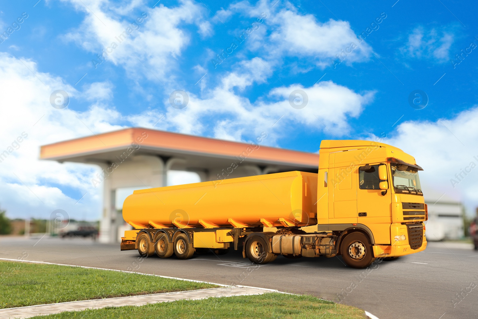 Image of Bright truck driving from modern gas filling station