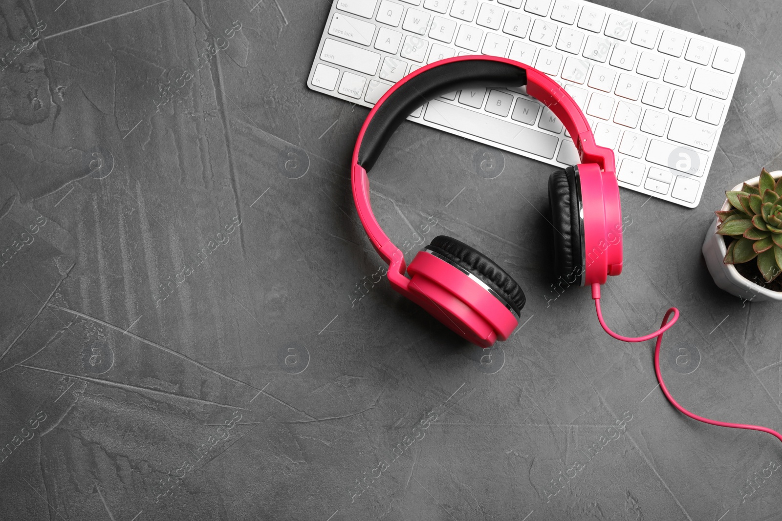 Photo of Flat lay composition with headphones and keyboard on table. Space for text