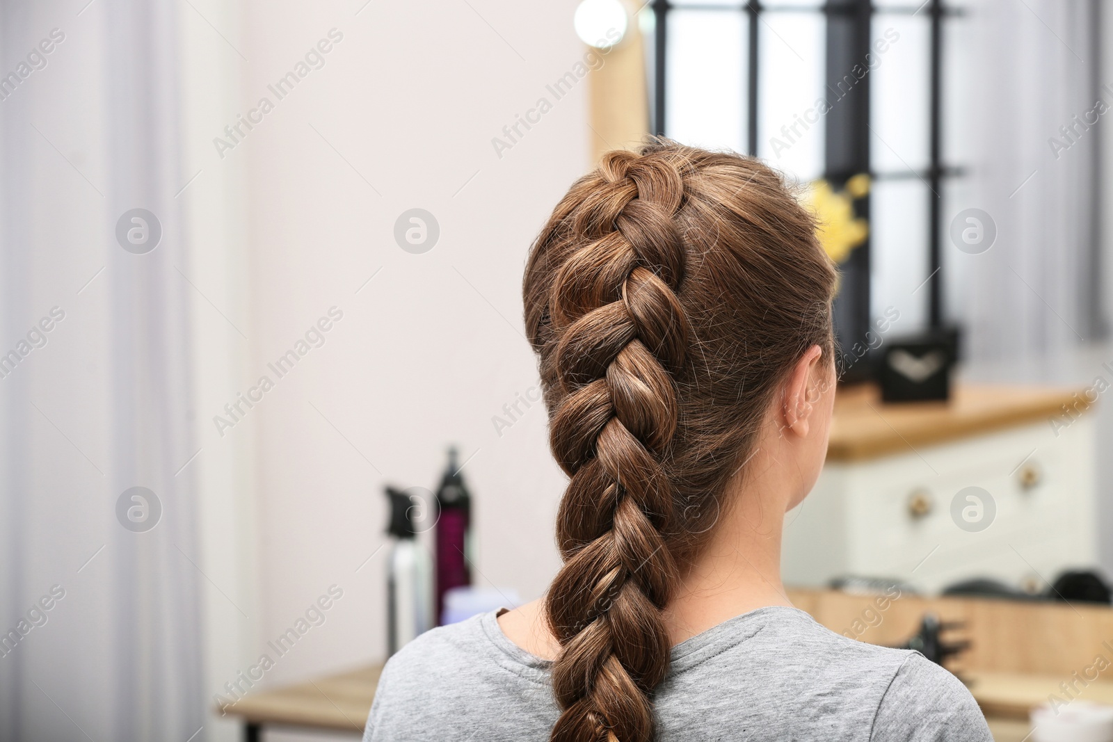 Photo of Woman with braided hair in professional salon