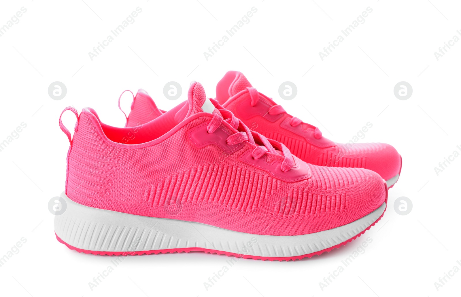 Photo of Pair of stylish pink sneakers on white background