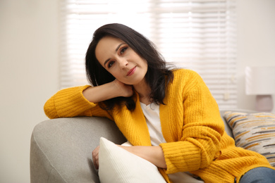Photo of Beautiful mature woman on sofa at home