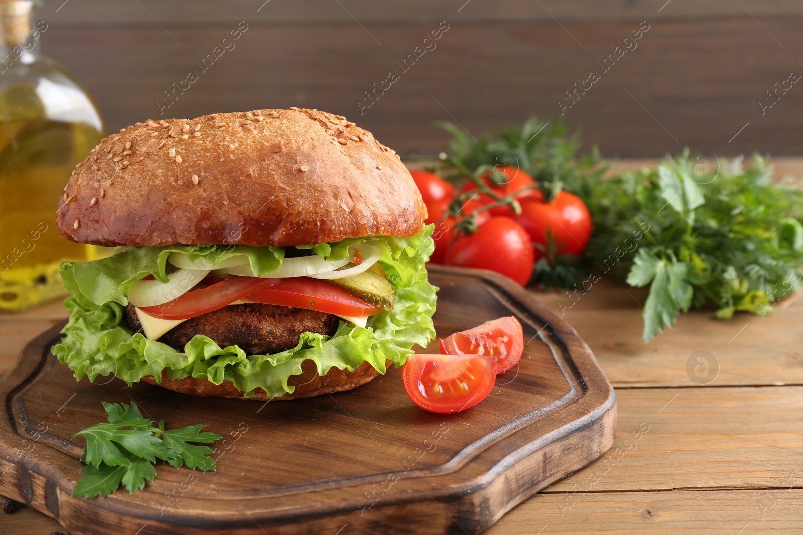 Photo of Delicious vegetarian burger served on wooden table