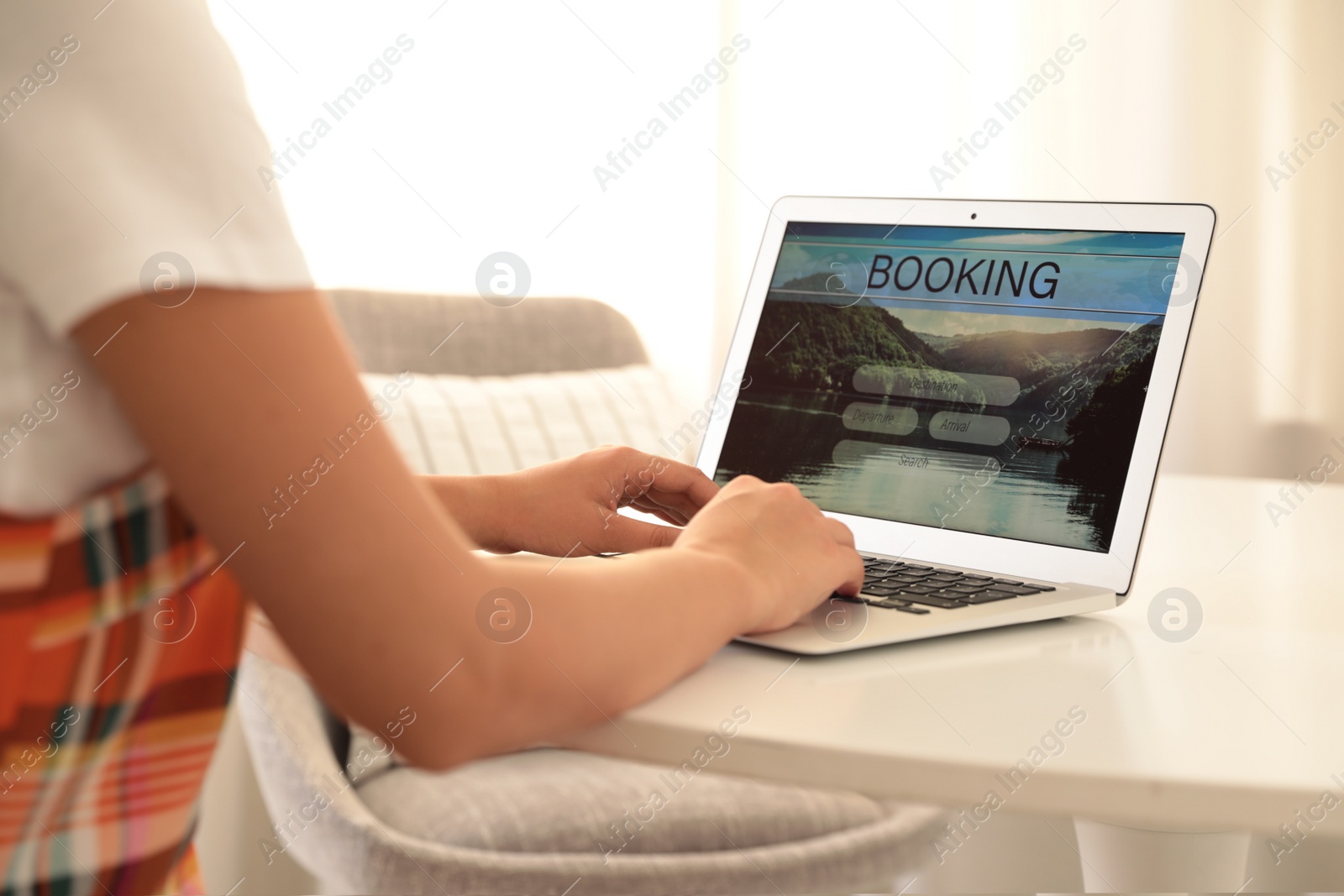 Photo of Woman booking tickets online indoors, closeup. Travel agency concept