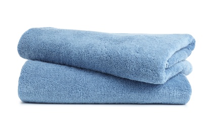 Folded clean soft towels on white background