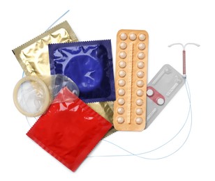 Contraceptive pills, condoms and intrauterine device isolated on white, top view. Different birth control methods