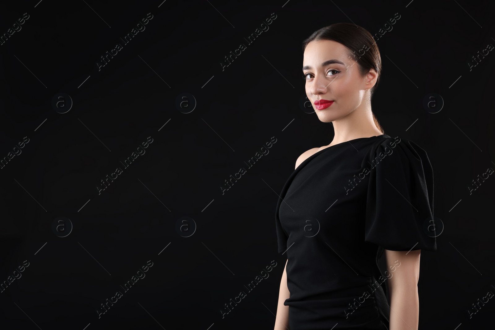 Photo of Beautiful young woman on black background, space for text