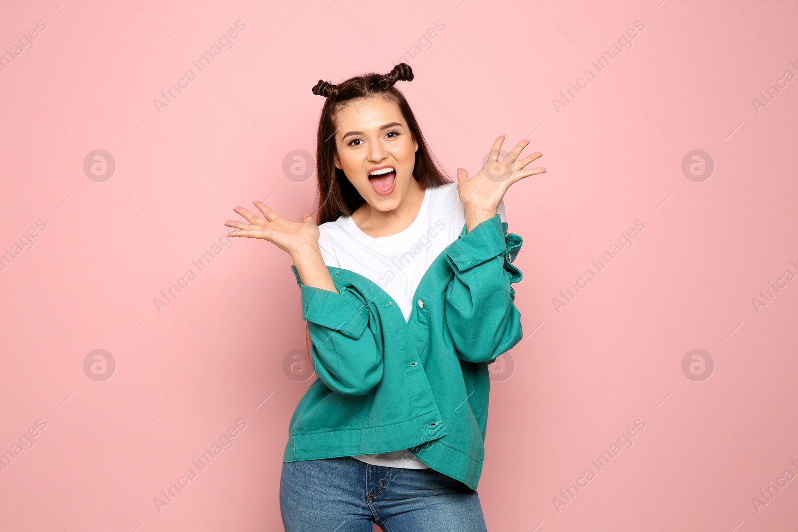 Photo of Portrait of emotional young woman in stylish clothes on color background