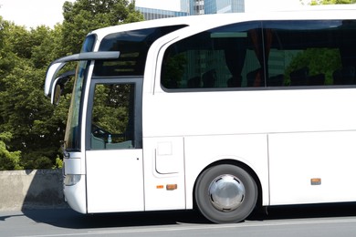 Photo of Modern white bus on road outdoors. Public transport