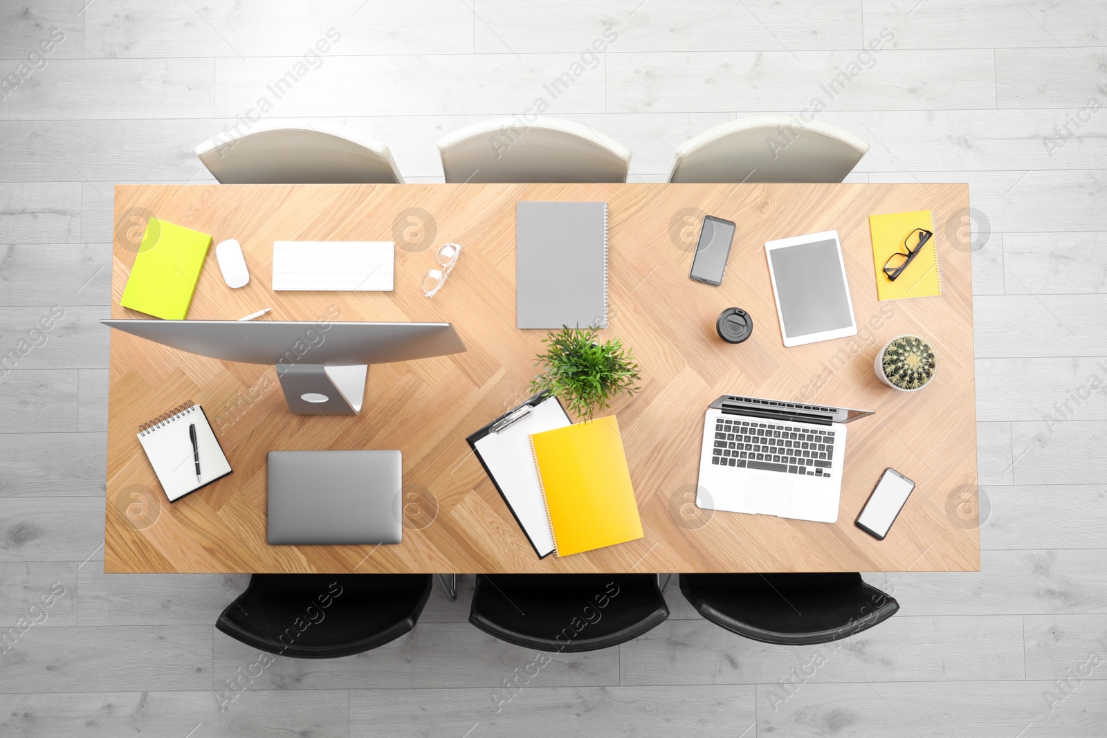 Photo of Modern office table with devices and chairs, top view